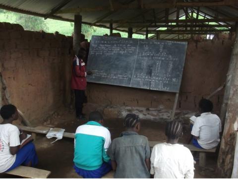 A teacher and his pupils in a classroom at Bikaniro Primary School